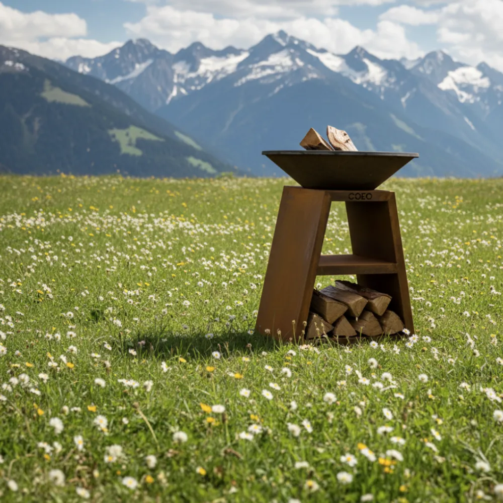 COEO brazier in Corten steel with rust patina next to a black powder-coated steel brazier