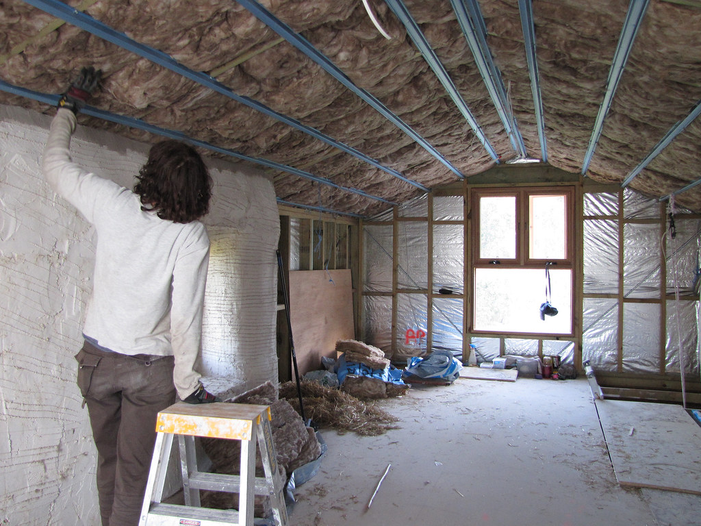 Insulation being installed in an attic to improve home energy efficiency