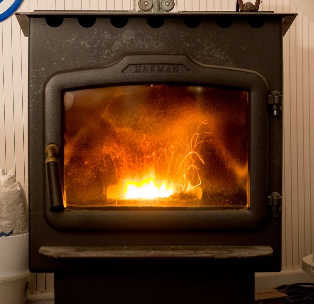 Pellet stove in operation, flames visible through the glass, winter ambiance